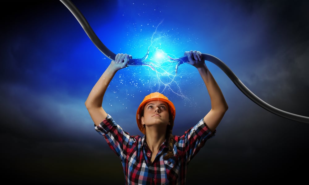 Image of woman holding electricity cable above head