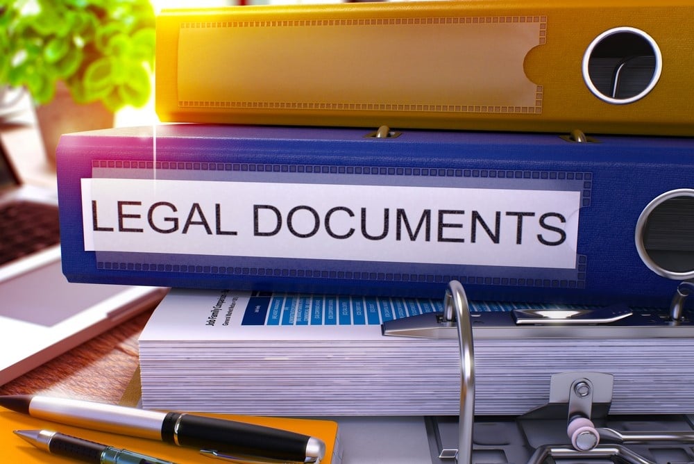 Blue Office Folder with Inscription Legal Documents on Office Desktop with Office Supplies and Modern Laptop. Legal Documents Business Concept on Blurred Background. Legal Documents - Toned Image. 3D.